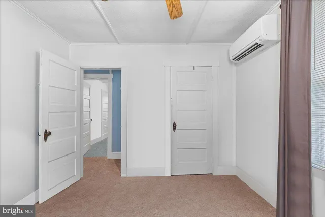 a view of a room with window and a ceiling fan