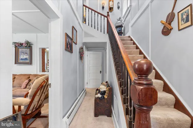 a view of staircase with furniture and a window