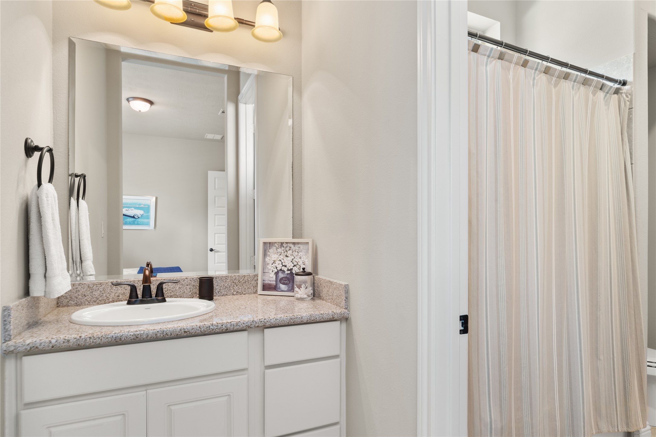 19813 Cullen Ridge Drive Porter, TX 77365 - Photo 32 of 44 This elegant Jack and Jill bathroom offers functionality and style with its sleek granite countertop, modern fixtures, and convenient access from adjoining rooms, perfect for seamless sharing.