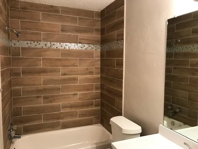 a bathroom with a bathtub and toilet