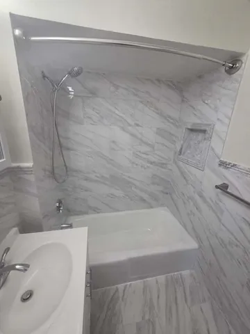 a bathroom with a sink and shower