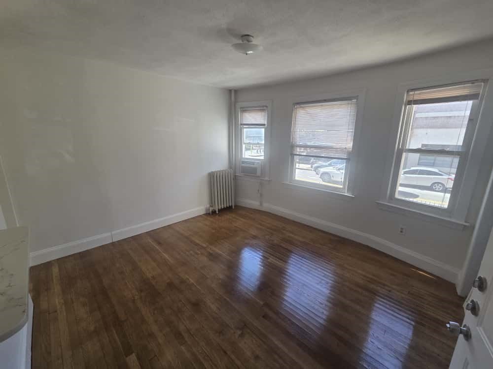 100 St Marys Street, Unit 1 Boston, MA 02215 - Photo 2 of 12 a view of empty room with wooden floor and fan