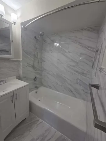 a bathroom with a bathtub and a sink