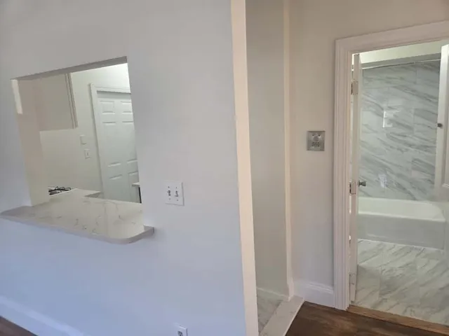 a bathroom with a tub and a shower