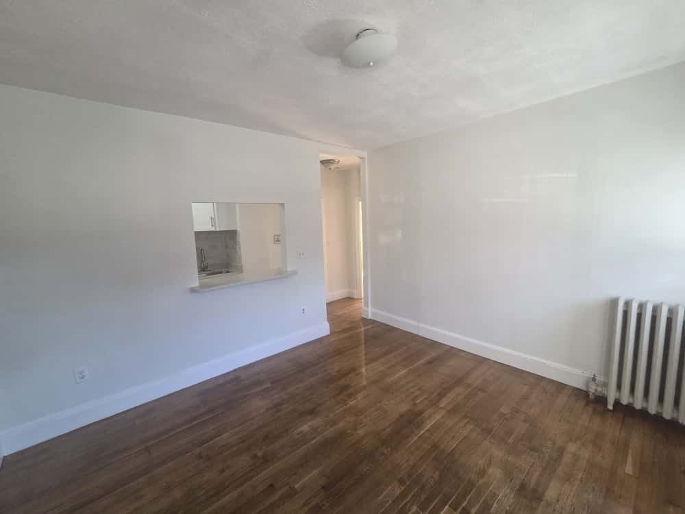 100 St Marys Street, Unit 1 Boston, MA 02215 - Photo 5 of 12 an empty room with wooden floor and windows