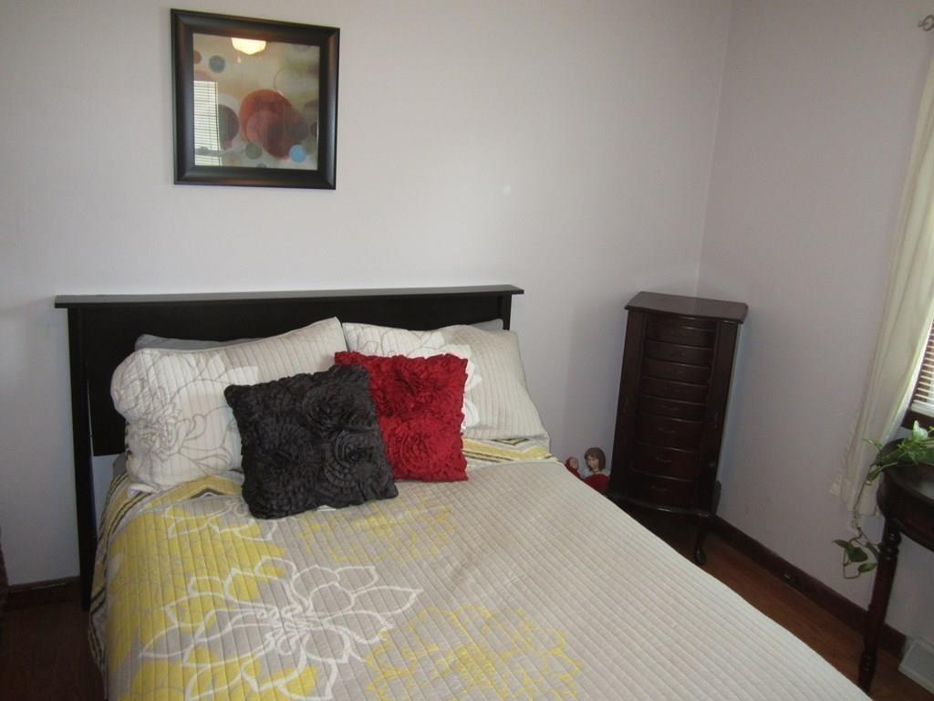 97 Fallston Street Springfield, MA 01119 - Photo 19 of 35 a bed room with a bed and a painting on the wall