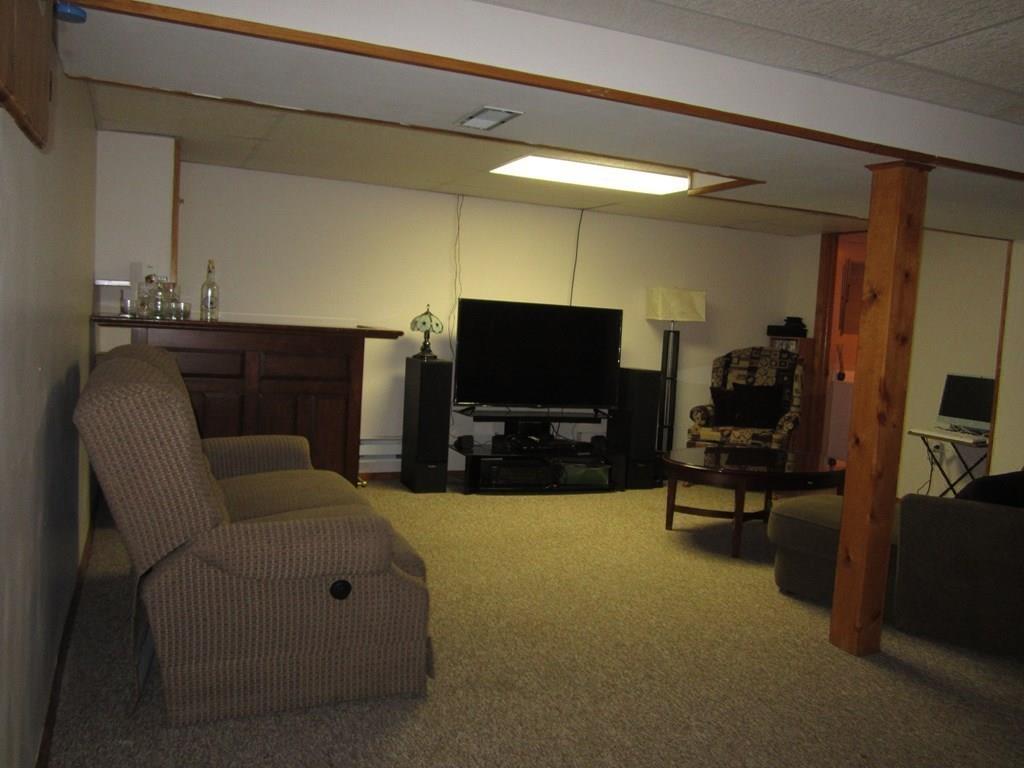 97 Fallston Street Springfield, MA 01119 - Photo 25 of 35 a living room with furniture and a flat screen tv