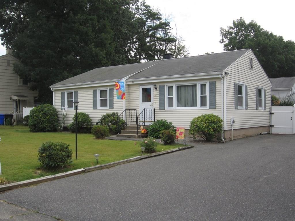 97 Fallston Street Springfield, MA 01119 - Photo 4 of 35 a front view of a house with a garden and yard