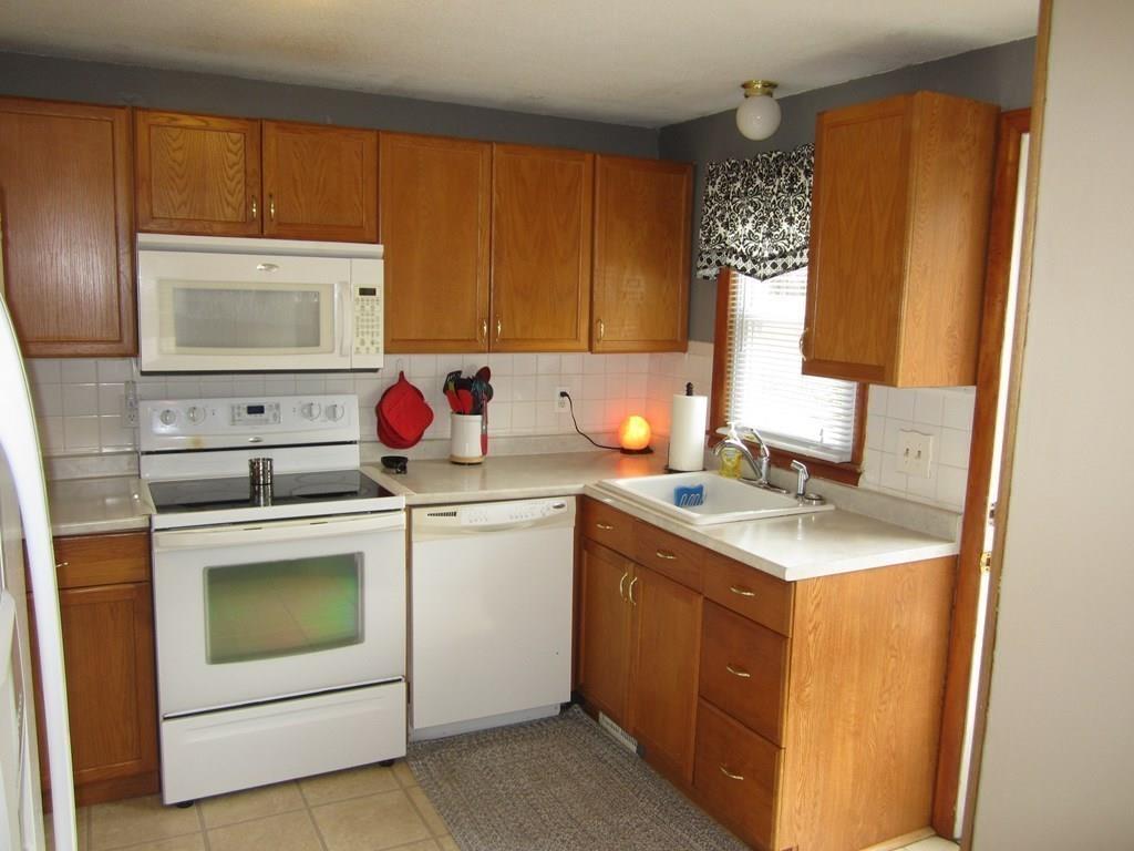 97 Fallston Street Springfield, MA 01119 - Photo 6 of 35 a kitchen with a sink stove and microwave