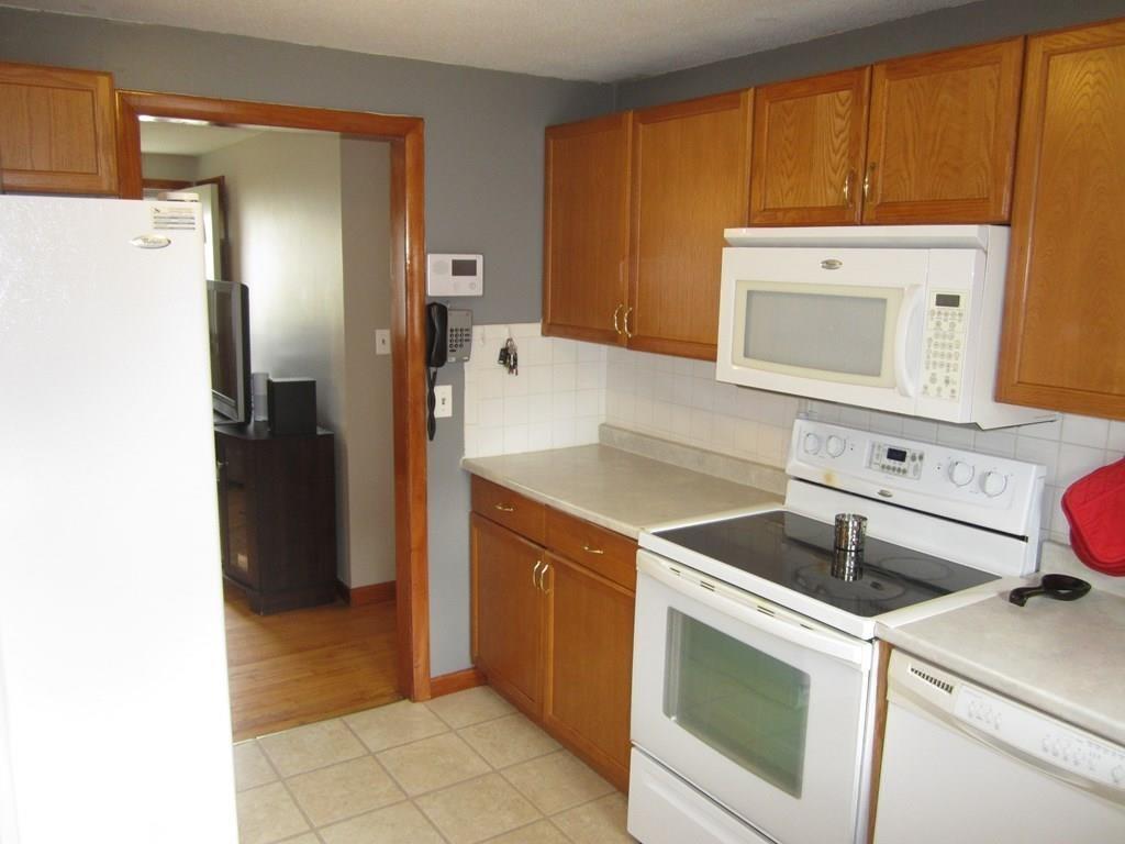 97 Fallston Street Springfield, MA 01119 - Photo 7 of 35 a kitchen with a stove top oven and refrigerator