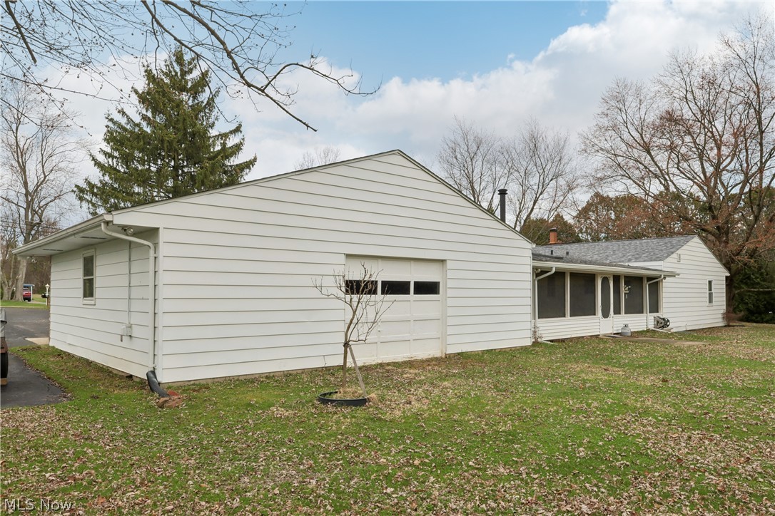 402 Yager Road Clinton, OH 44216 - Photo 35 of 38 Back / side of the home with a second garage door entrance, and the sun / 3 season room