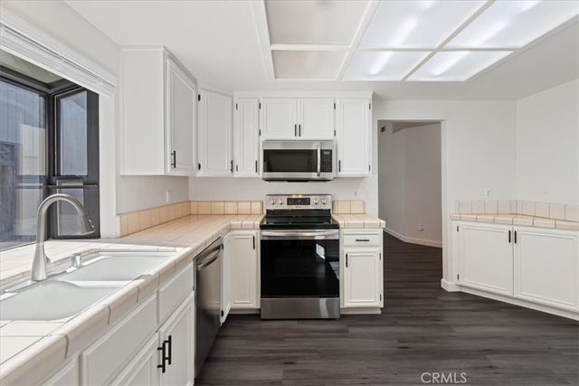 a kitchen with stainless steel appliances granite countertop a stove and a sink