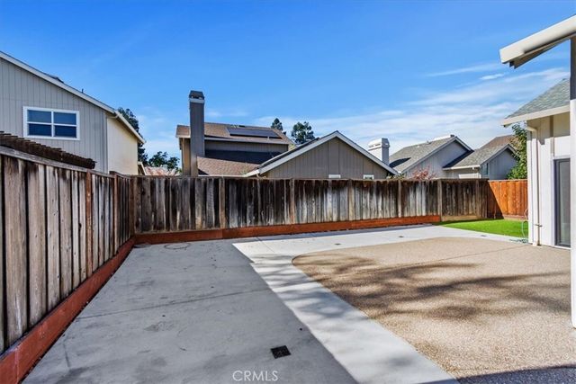 a view of a house with wooden fence