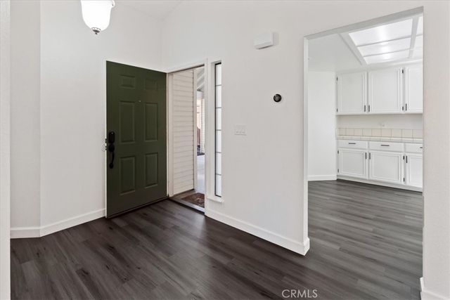 a view of a kitchen with wooden floor and a sink