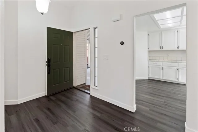 a view of a kitchen with wooden floor and a sink