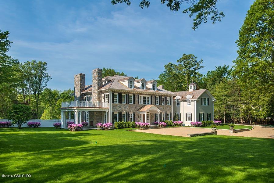 1 Doverton Drive Greenwich, CT 06831 - Photo 1 of 34 a view of a house with a big yard and large trees