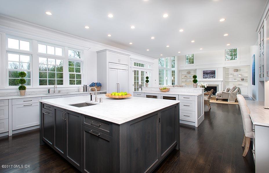 1 Doverton Drive Greenwich, CT 06831 - Photo 14 of 34 a kitchen with counter top space sink stove and wooden floor