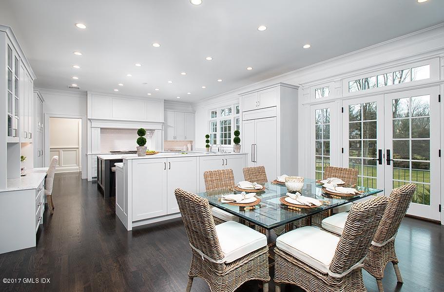 1 Doverton Drive Greenwich, CT 06831 - Photo 15 of 34 a dining room with stainless steel appliances kitchen island granite countertop a dining table chairs and a refrigerator