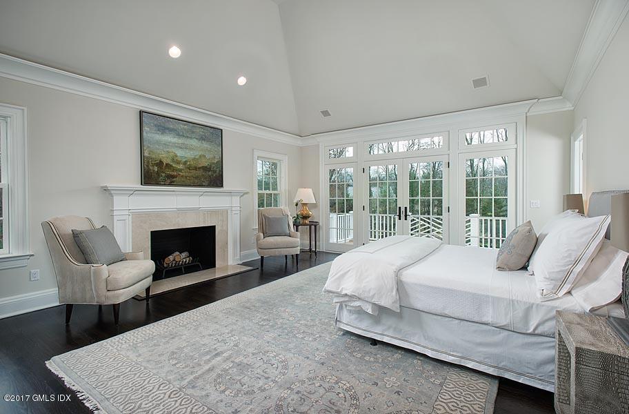 1 Doverton Drive Greenwich, CT 06831 - Photo 19 of 34 a bedroom with a bed and glass window