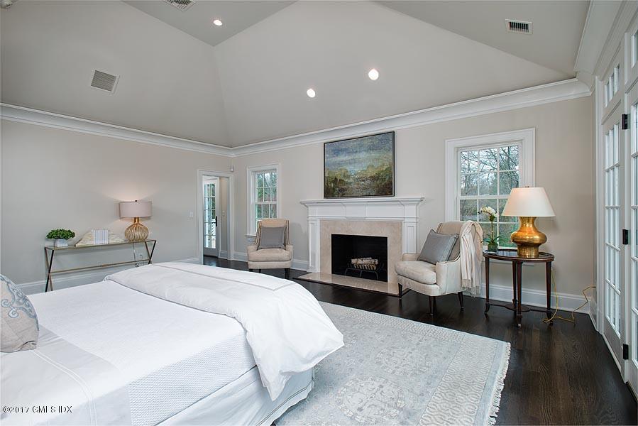 1 Doverton Drive Greenwich, CT 06831 - Photo 20 of 34 a spacious bedroom with a large bed and a fireplace