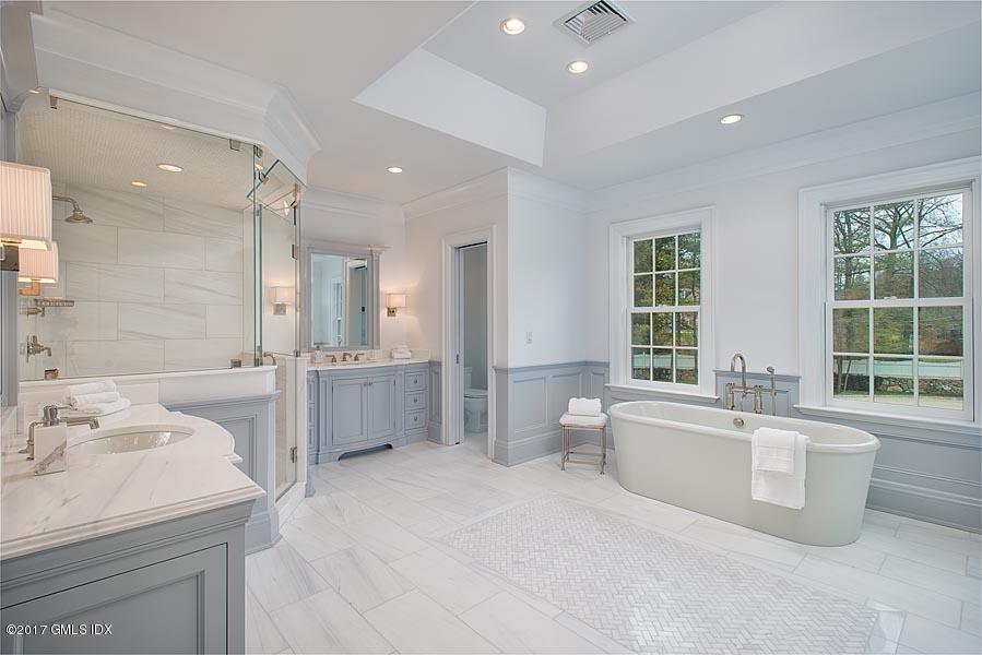 1 Doverton Drive Greenwich, CT 06831 - Photo 22 of 34 a large spacious bathroom with a double vanity sink a large mirror and a bathtub