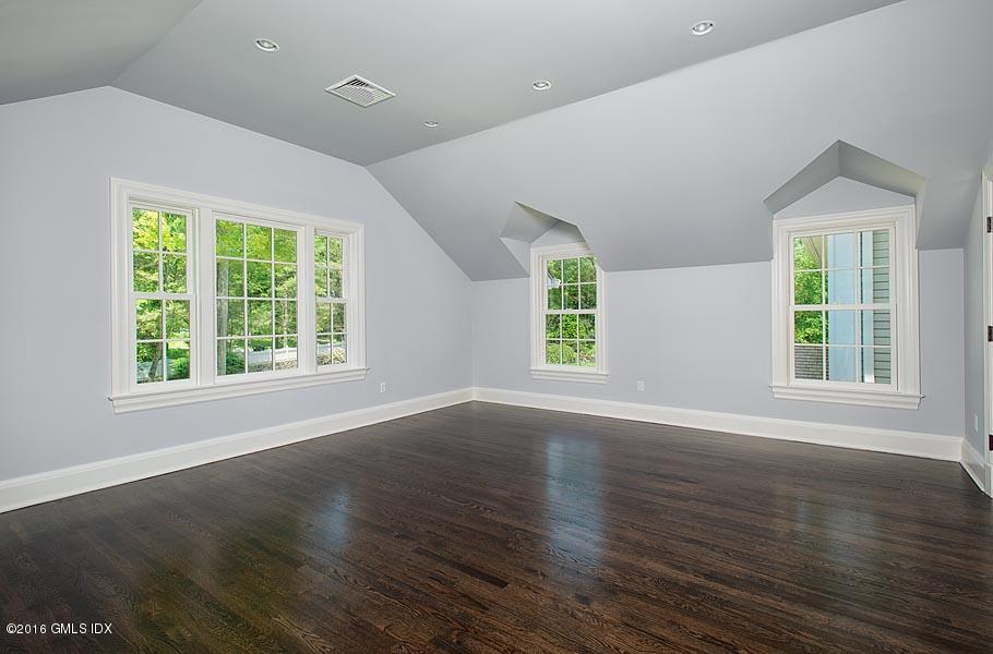 1 Doverton Drive Greenwich, CT 06831 - Photo 25 of 34 a view of an empty room with wooden floor and a window