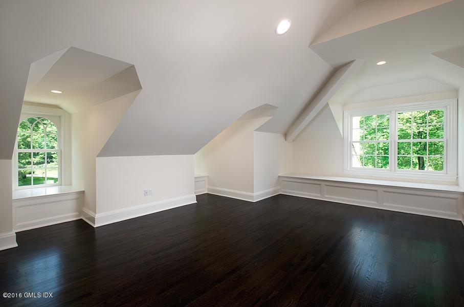 1 Doverton Drive Greenwich, CT 06831 - Photo 27 of 34 an empty room with wooden floor and windows