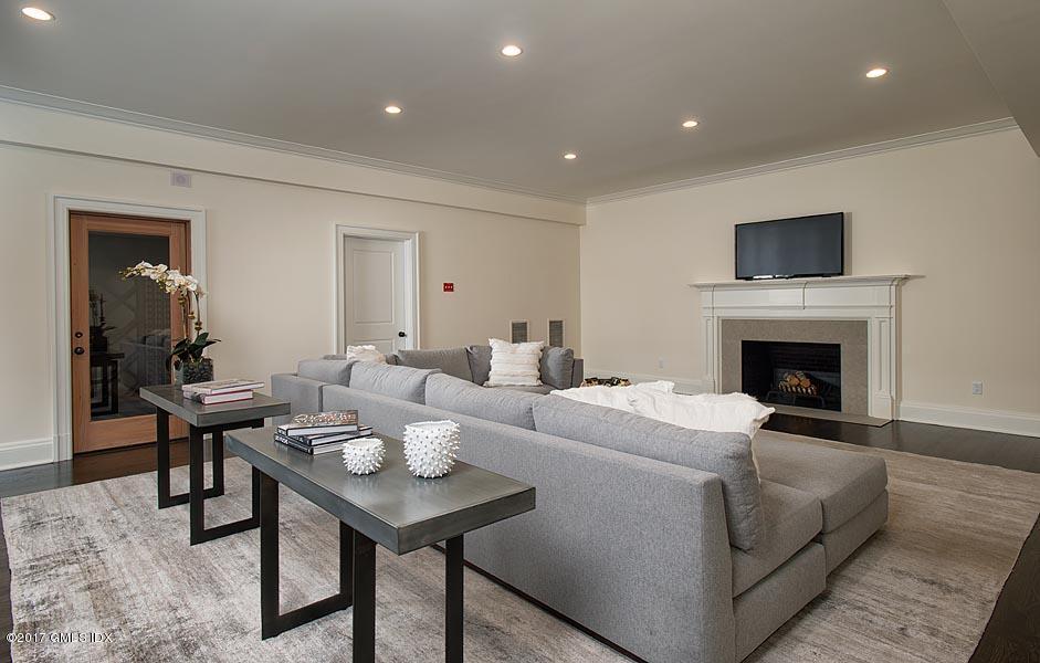 1 Doverton Drive Greenwich, CT 06831 - Photo 29 of 34 a living room with furniture a flat screen tv and a fireplace