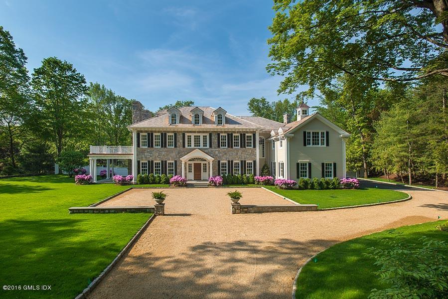 1 Doverton Drive Greenwich, CT 06831 - Photo 3 of 34 a front view of a house with a yard
