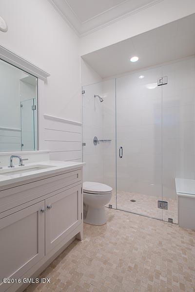 1 Doverton Drive Greenwich, CT 06831 - Photo 33 of 34 a bathroom with a granite countertop sink a toilet and shower