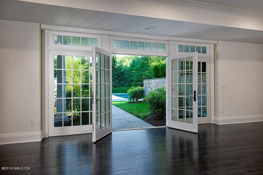 1 Doverton Drive Greenwich, CT 06831 - Photo 34 of 34 a view of empty room with wooden floor and floor to ceiling windows
