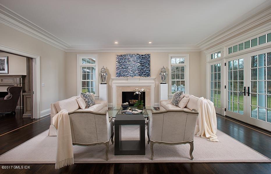 1 Doverton Drive Greenwich, CT 06831 - Photo 8 of 34 a living room with furniture a large window and a fireplace