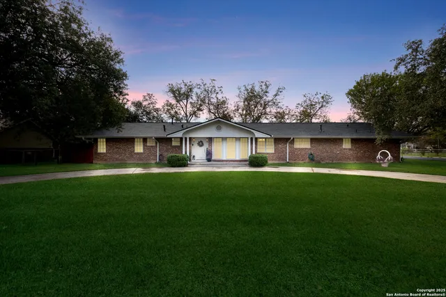 a front view of house with yard and green space