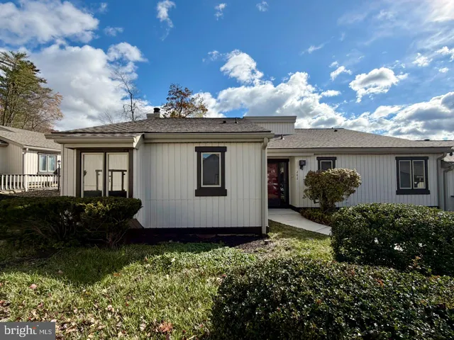 a front view of house with a garden