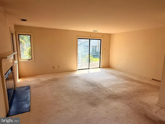 a view of an empty room with a fireplace