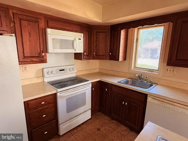 a kitchen with a sink stove and microwave