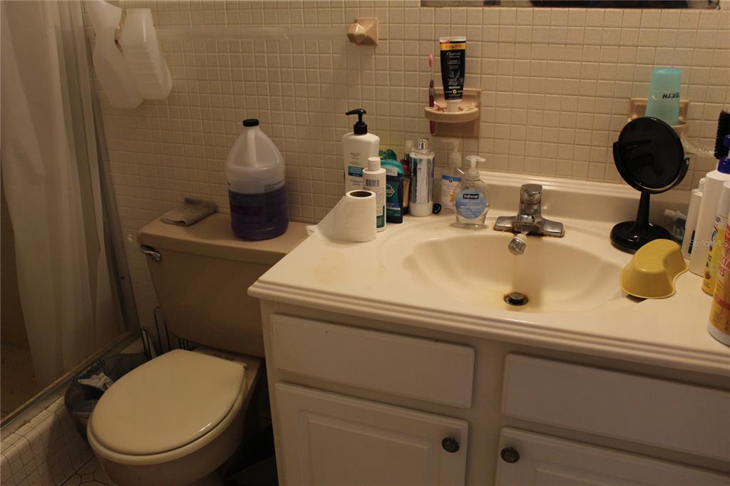 2755 Taylor Road Auburndale, FL 33823 - Photo 40 of 86 a bathroom with a sink mirror and toilet