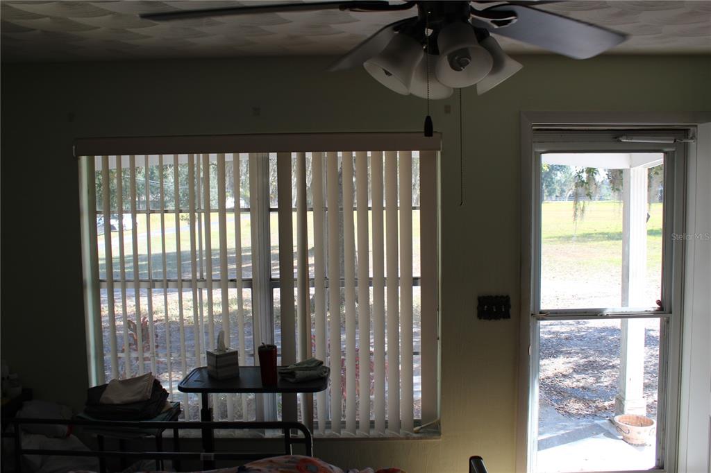 2755 Taylor Road Auburndale, FL 33823 - Photo 42 of 86 a room with wooden floor and a ceiling fan