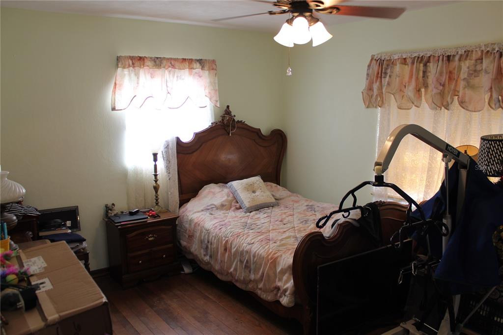 2755 Taylor Road Auburndale, FL 33823 - Photo 48 of 86 a bedroom with a bed and a chandelier