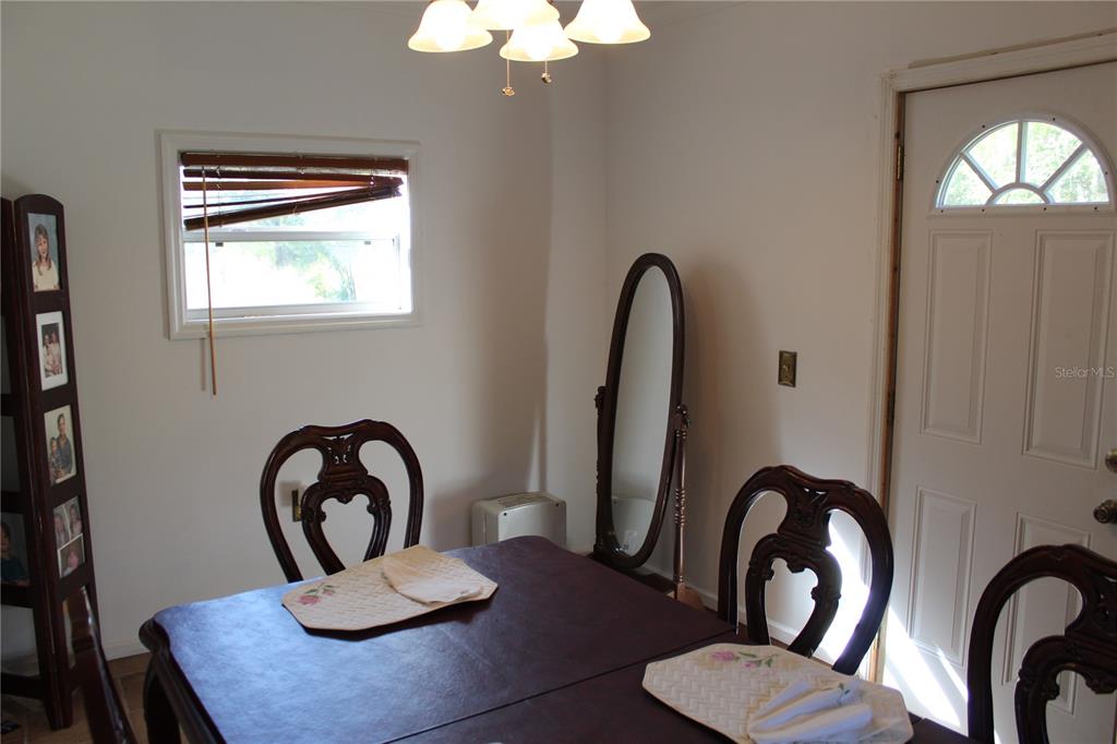 2755 Taylor Road Auburndale, FL 33823 - Photo 59 of 86 a view of a dining room with furniture and chandelier