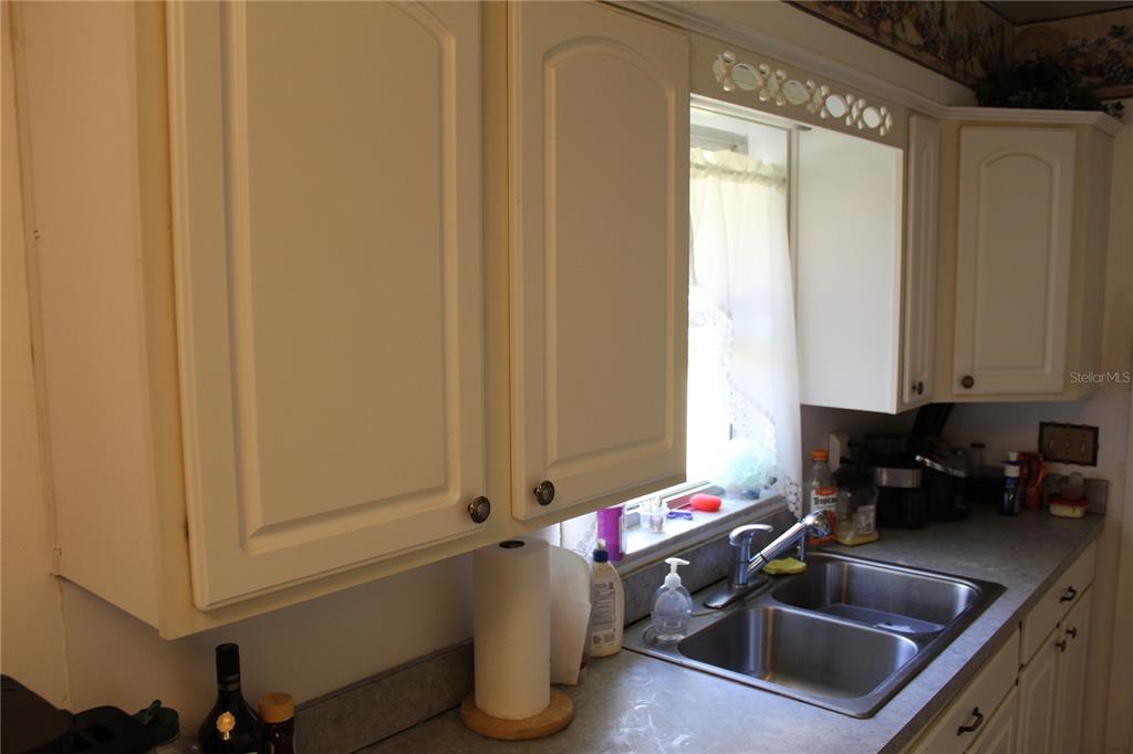2755 Taylor Road Auburndale, FL 33823 - Photo 65 of 86 a kitchen with a sink cabinets and window