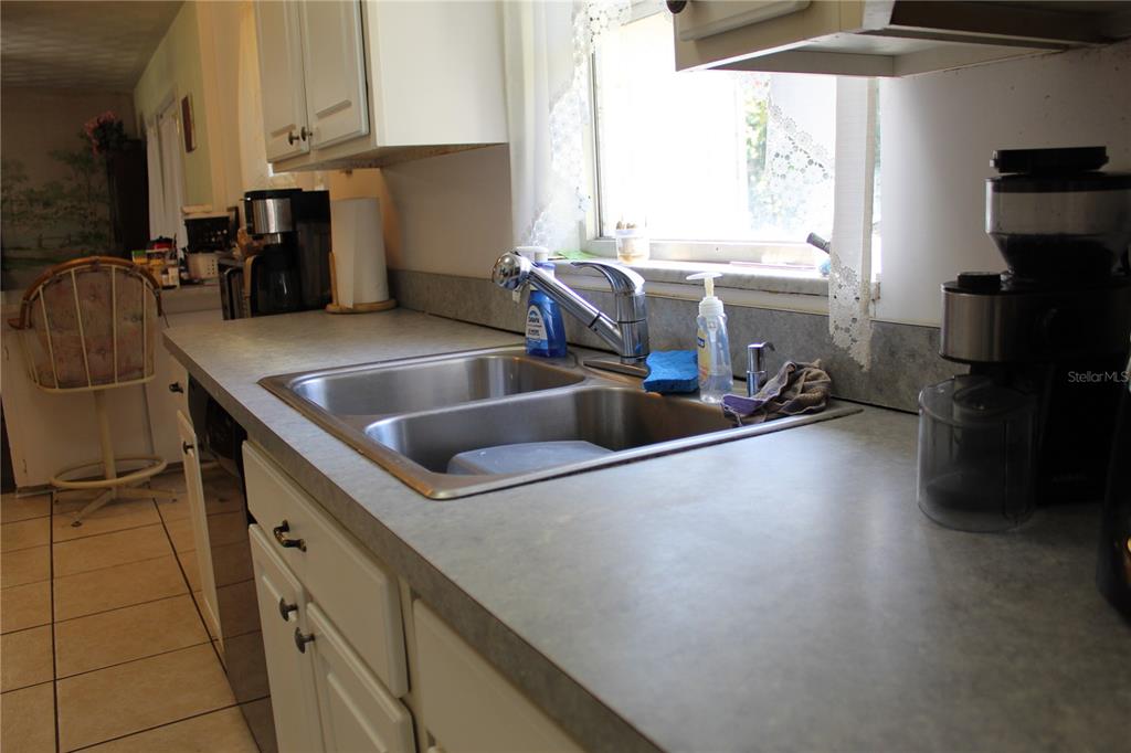 2755 Taylor Road Auburndale, FL 33823 - Photo 76 of 86 a kitchen with stainless steel appliances a sink a stove and a refrigerator