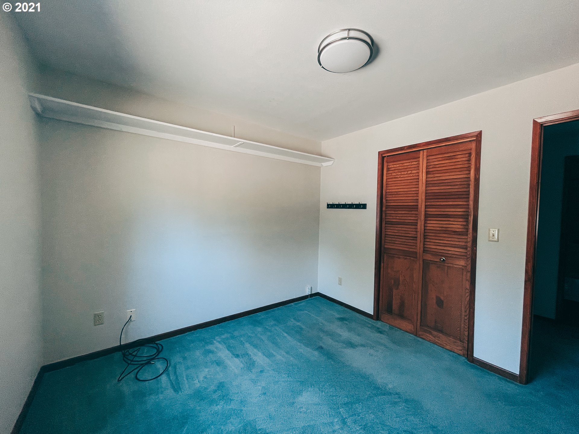 18148 Rainbow Rock Road Brookings, OR 97415 - Photo 22 of 32 a view of room with walk in closet and wooden floor