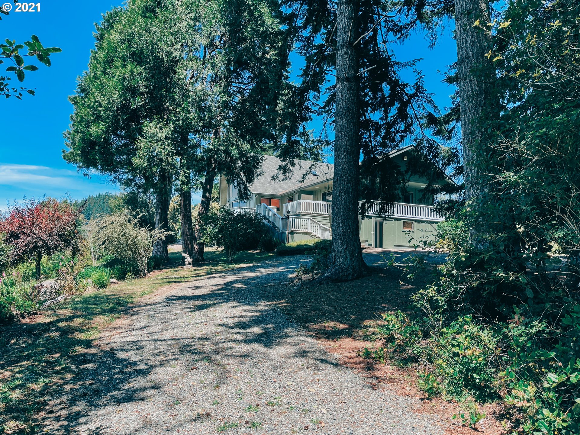 18148 Rainbow Rock Road Brookings, OR 97415 - Photo 5 of 32 a front view of a house with a yard