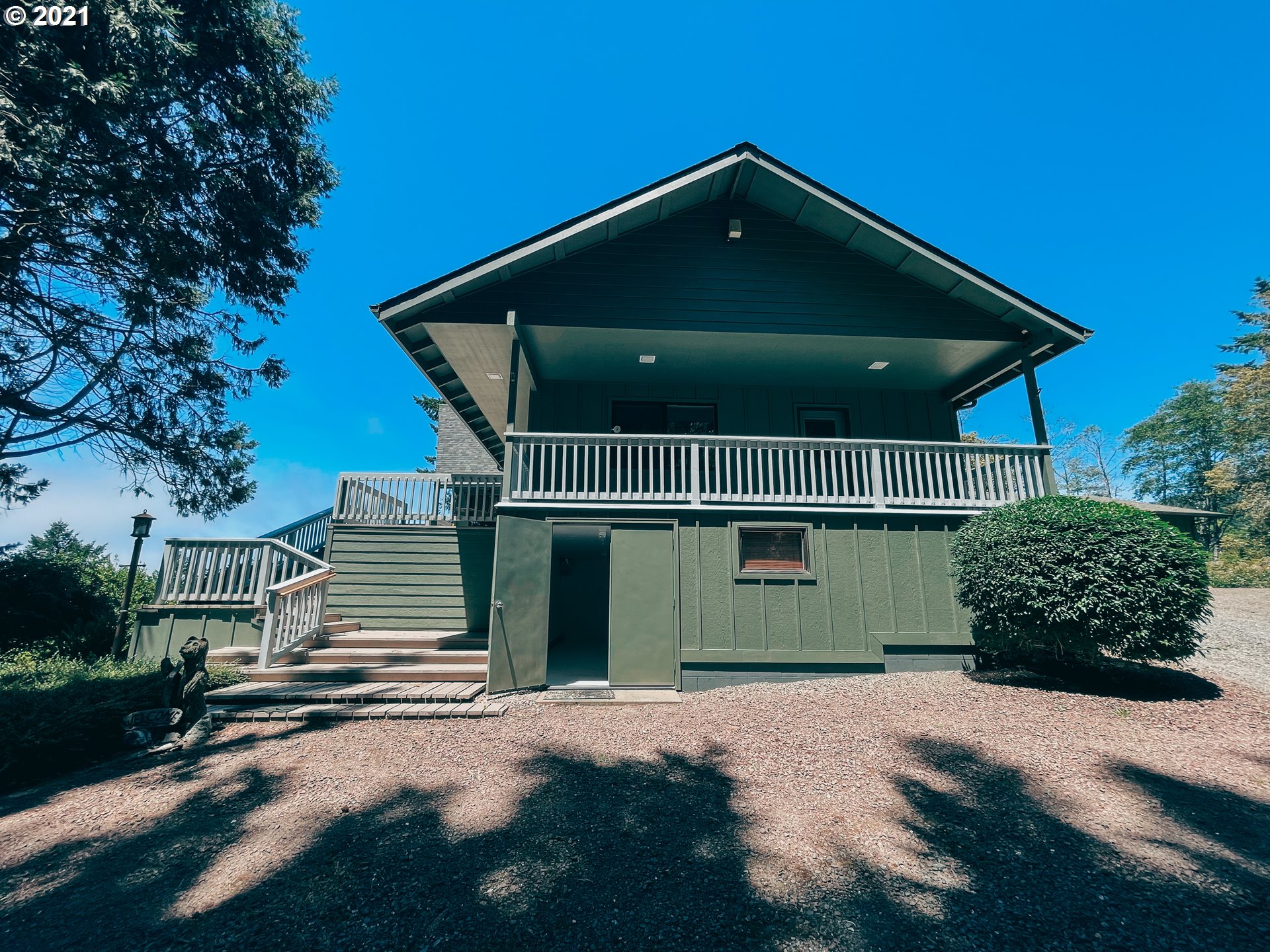 18148 Rainbow Rock Road Brookings, OR 97415 - Photo 6 of 32 a front view of a house with a yard