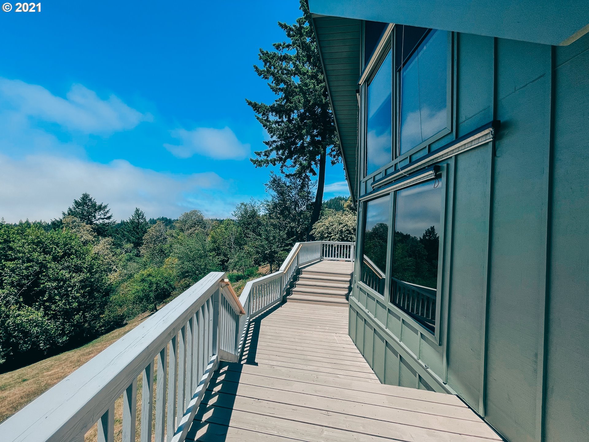 18148 Rainbow Rock Road Brookings, OR 97415 - Photo 7 of 32 a balcony with wooden floor and fence