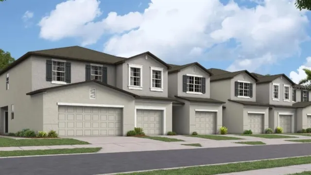 a front view of a house with a garden and trees