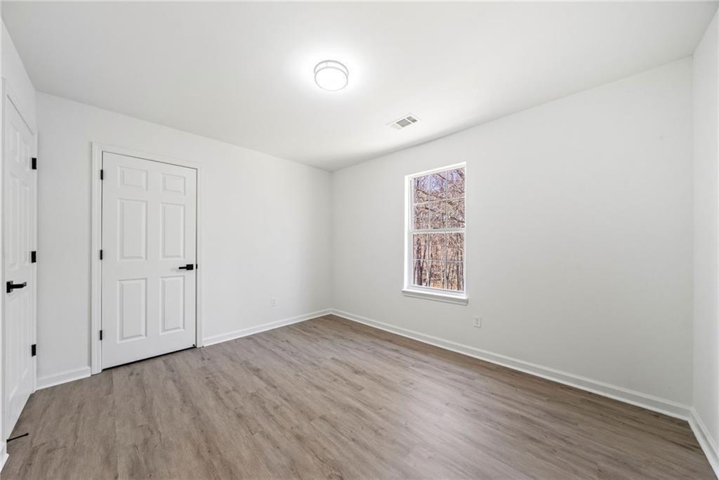 900 Melrose Park Place Lawrenceville, GA 30044 - Photo 20 of 26 a view of room with window and hardwood floor