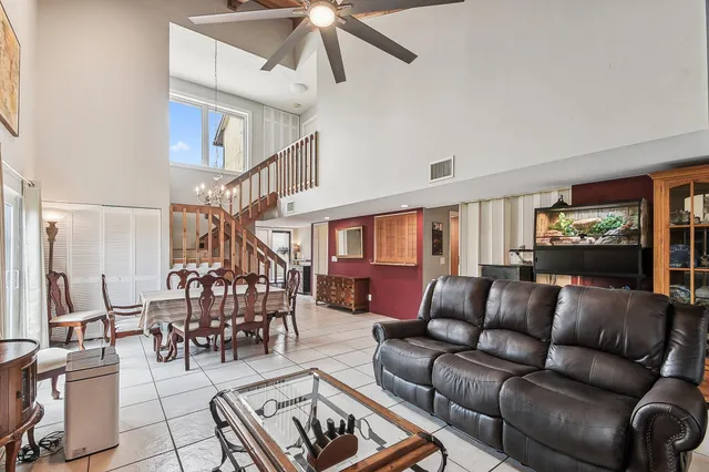 a bedroom with a bed a large window and flat screen tv