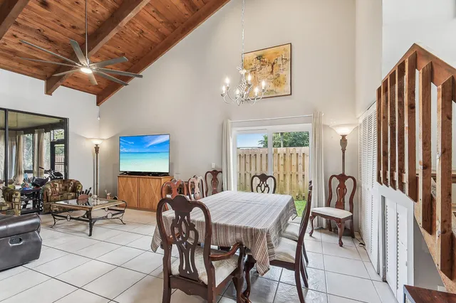 a view of a dining room with furniture and chandelier